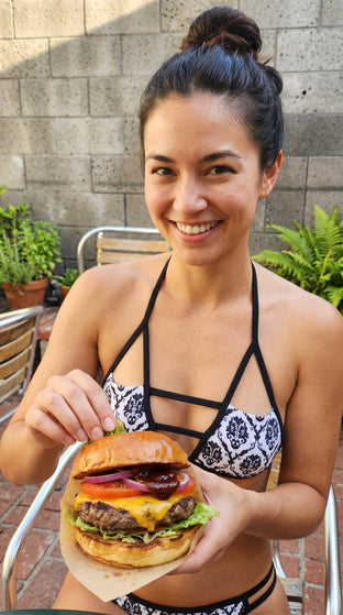 Woman wearing a pink bikini with a white background