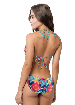 Woman wearing a colorful batik bikini on a white background
