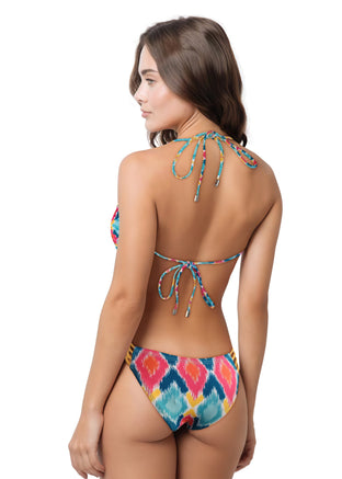 Woman wearing a colorful floral bikini on a white background