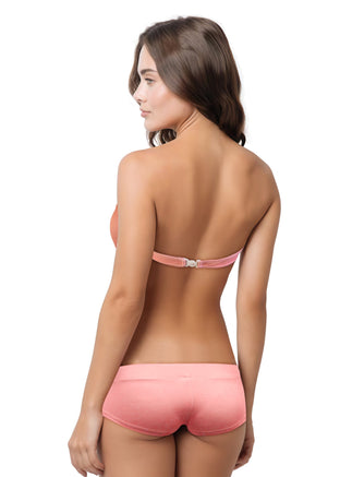 Woman wearing a salmon colored bikini set on a white background
