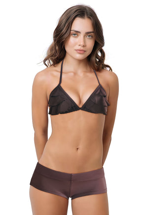 Woman wearing a black bikini with ruffled details on a white background