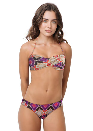 Woman wearing a colorful bikini set on a white background