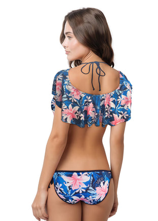 Woman wearing a floral bikini set against a white background