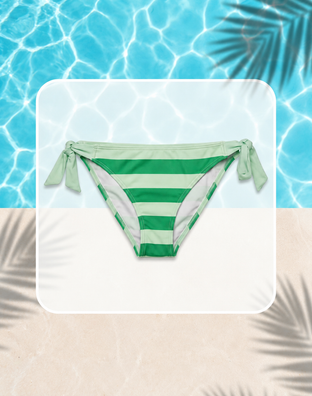 Striped bikini bottom with removable bow on a mannequin against a gray tiled background.