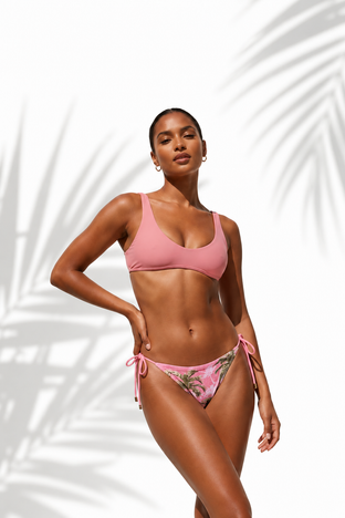 Woman wearing a tropical bikini with palm tree design on a white background