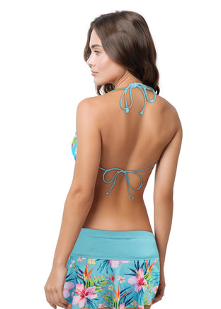 Woman wearing a colorful floral bikini set on a white background