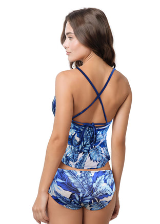 Woman wearing a tropical leaf patterned bikini on a white background