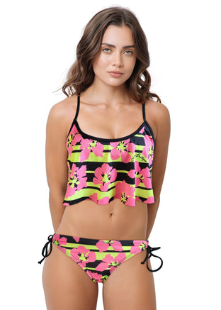 Woman wearing a colorful bikini with pink flowers and black stripes on a white background