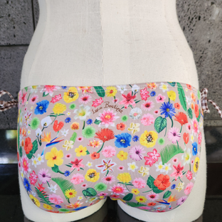 Floral-patterned bikini bottom with colorful flowers on a white background