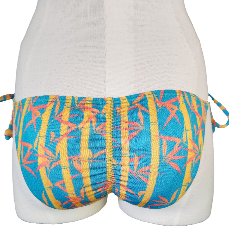 Floral bikini bottom with a pattern on a mannequin against a white background