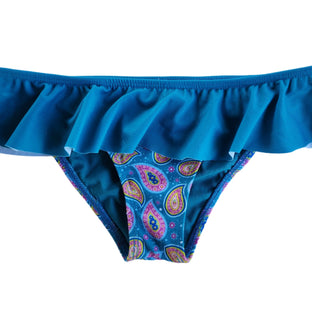 A model wearing a paisley skirted bikini bottom with a flirty ruffle waistband in teal blue.