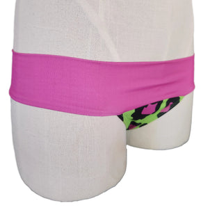Green and black leopard print bikini bottom with pink waistband on a mannequin.