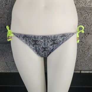 Woman wearing a patterned bikini on a white background