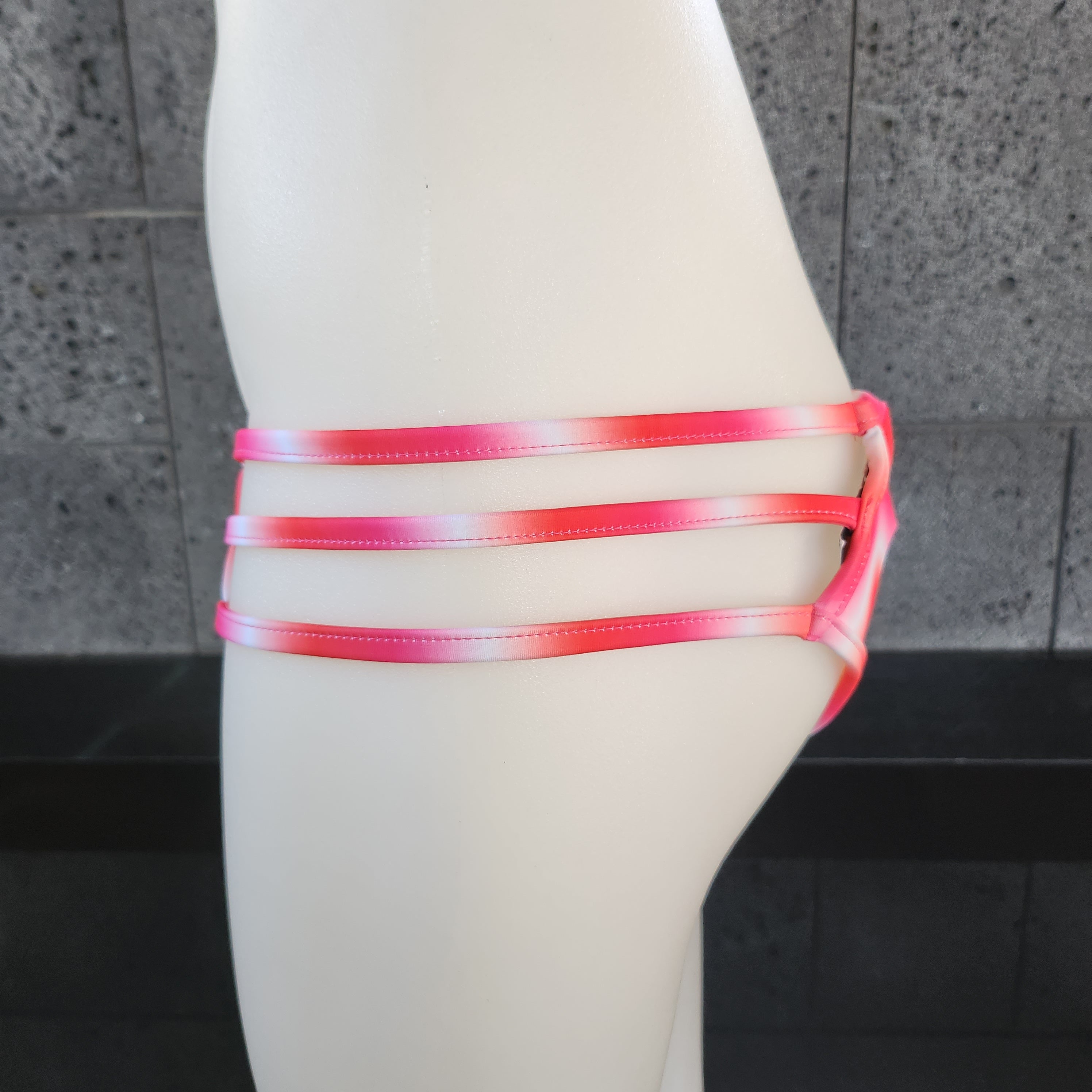 Purple Tie-dye bikini bottom on a mannequin against a gray background