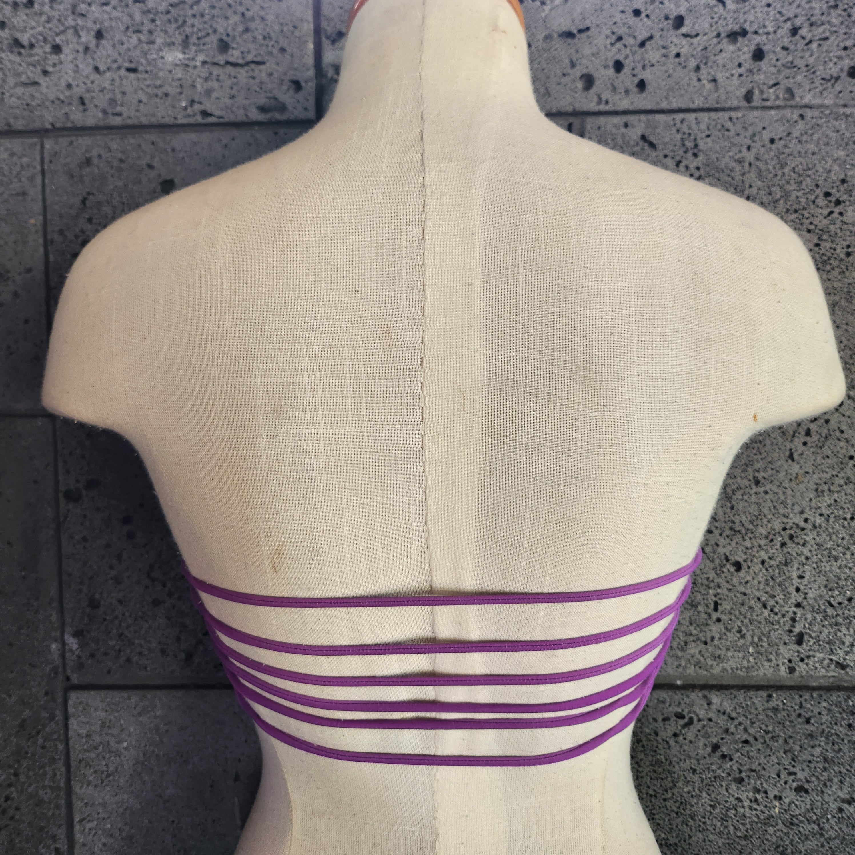 Colorful bandeau top on a mannequin against a white background.