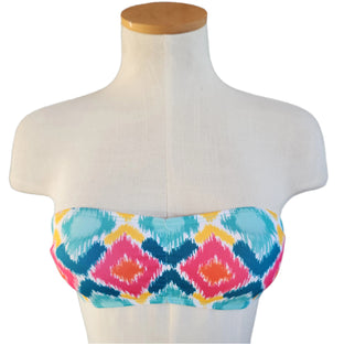 Colorful bandeau top on a mannequin against a white background.