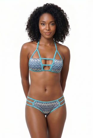 Woman wearing a bikini set with zig zag pattern on a white background.