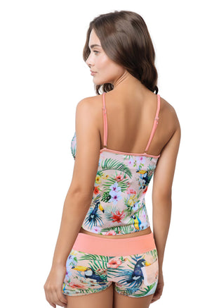 Woman wearing a tropical print swimsuit on a white background