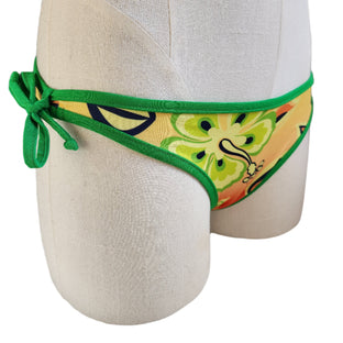 Colorful bikini bottom with green straps on a mannequin against a white background