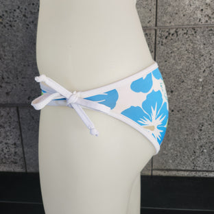 Floral bikini bottom on a mannequin with a textured gray background