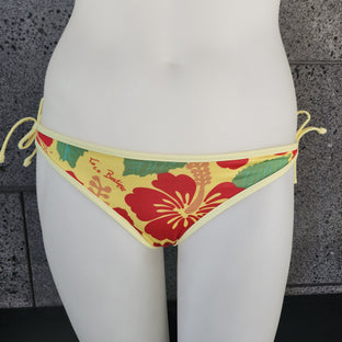 Floral bikini bottom on a mannequin with a textured gray background
