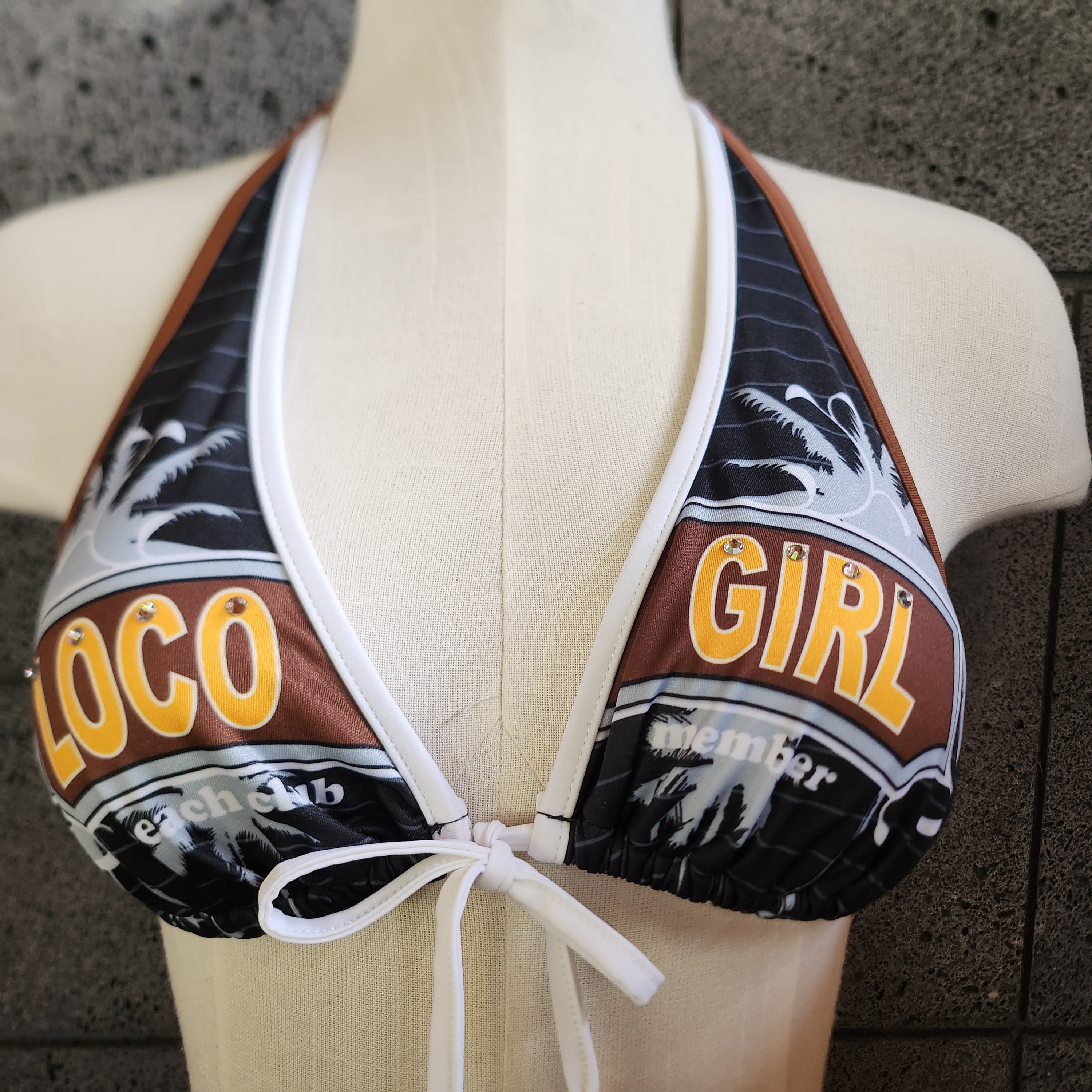 Loco Girl Black Bikini top on a mannequin against a concrete wall.