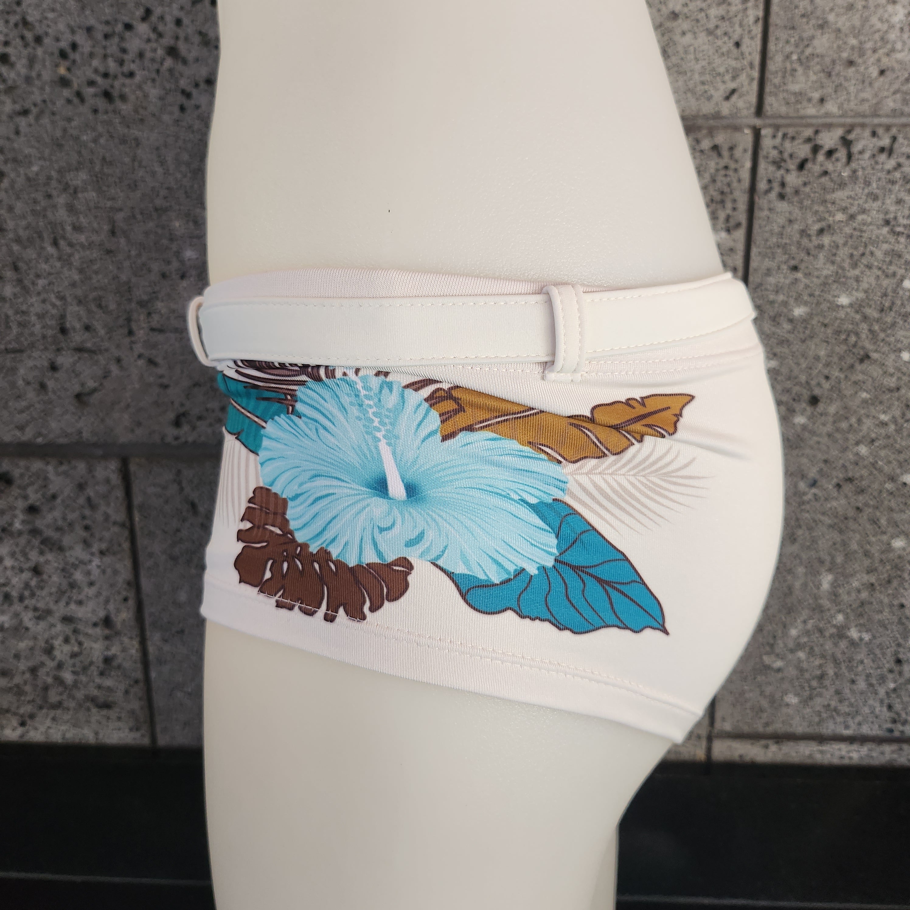 Red swimsuit with floral patterns on a white mannequin