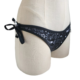 Black bikini bottom with 'Loco Boutique' text on a mannequin against a white background
