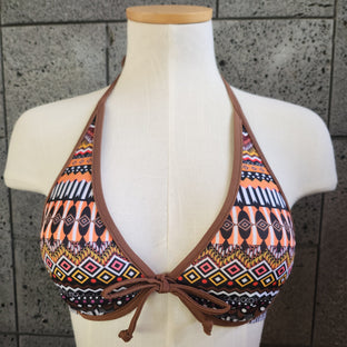 Bikini top with tribal pattern on a mannequin against a tiled background