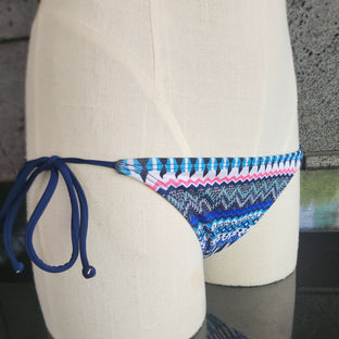 Decorative bikini bottom with a colorful pattern on a mannequin against a neutral background