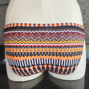 Colorful patterned bikini belt on a mannequin with a neutral background