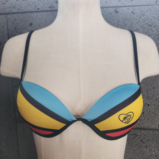 Colorful bikini top on a mannequin against a gray background