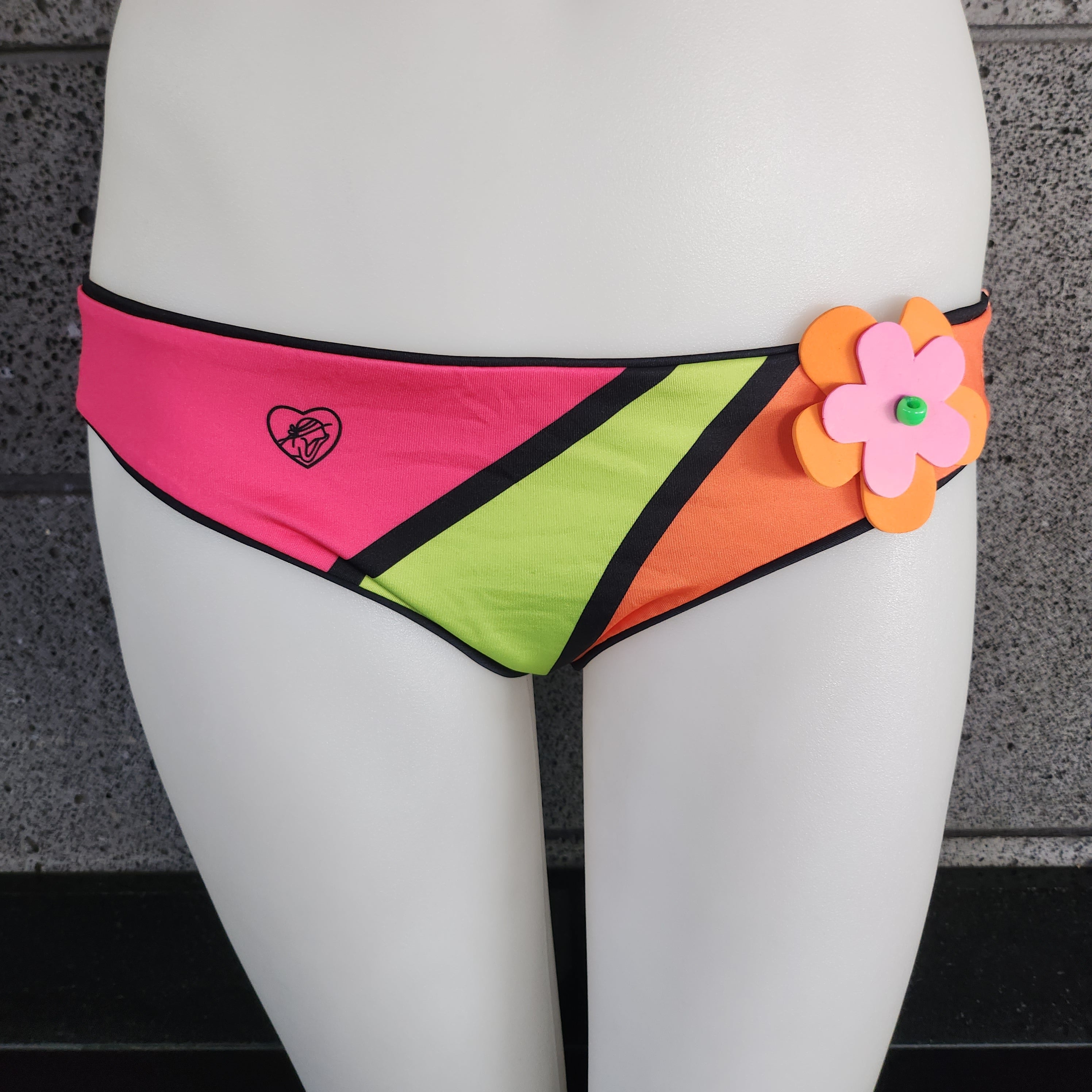 Colorful bikini bottom with a flower detail on a mannequin.