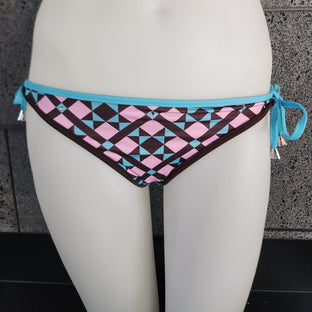 Bikini bottom with geometric pattern and blue straps on a white surface.