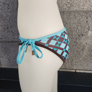 Bikini bottom with geometric pattern and blue straps on a white surface.