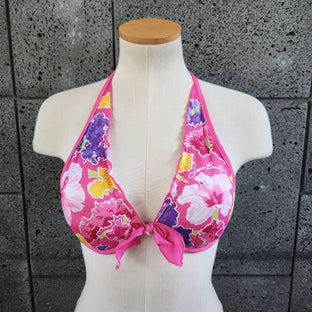 Floral bikini underwire top on a mannequin against a gray tiled wall