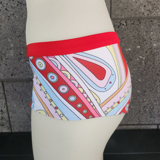 Colorful patterned boyshorts on a mannequin against a gray background.