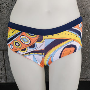 Colorful patterned boyshorts on a mannequin against a gray background.