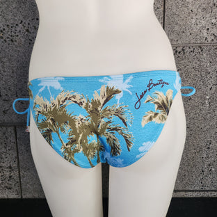 Woman wearing a tropical floral bikini on a white background