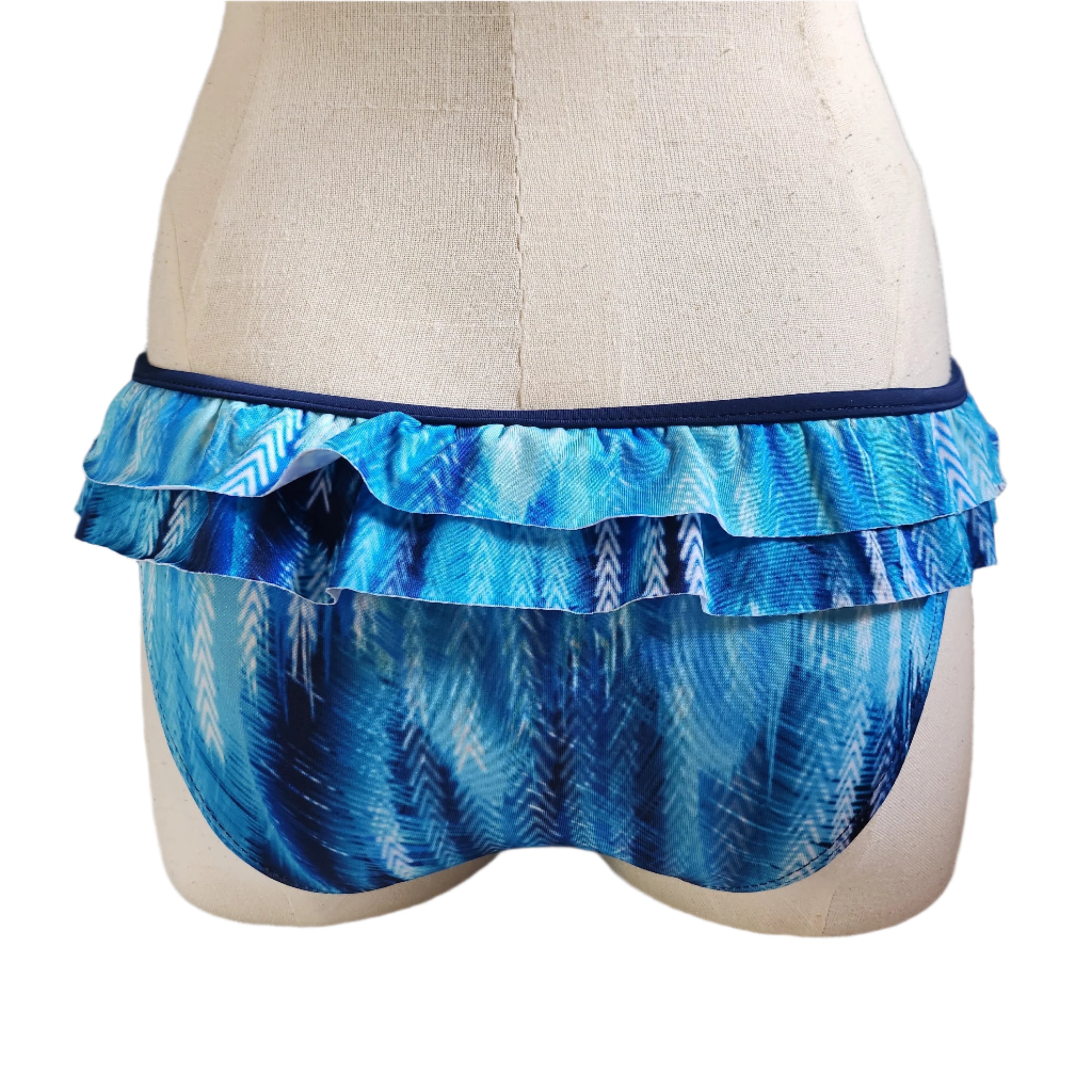 Mannequin wearing a brown ruffled bikini bottom with a white background