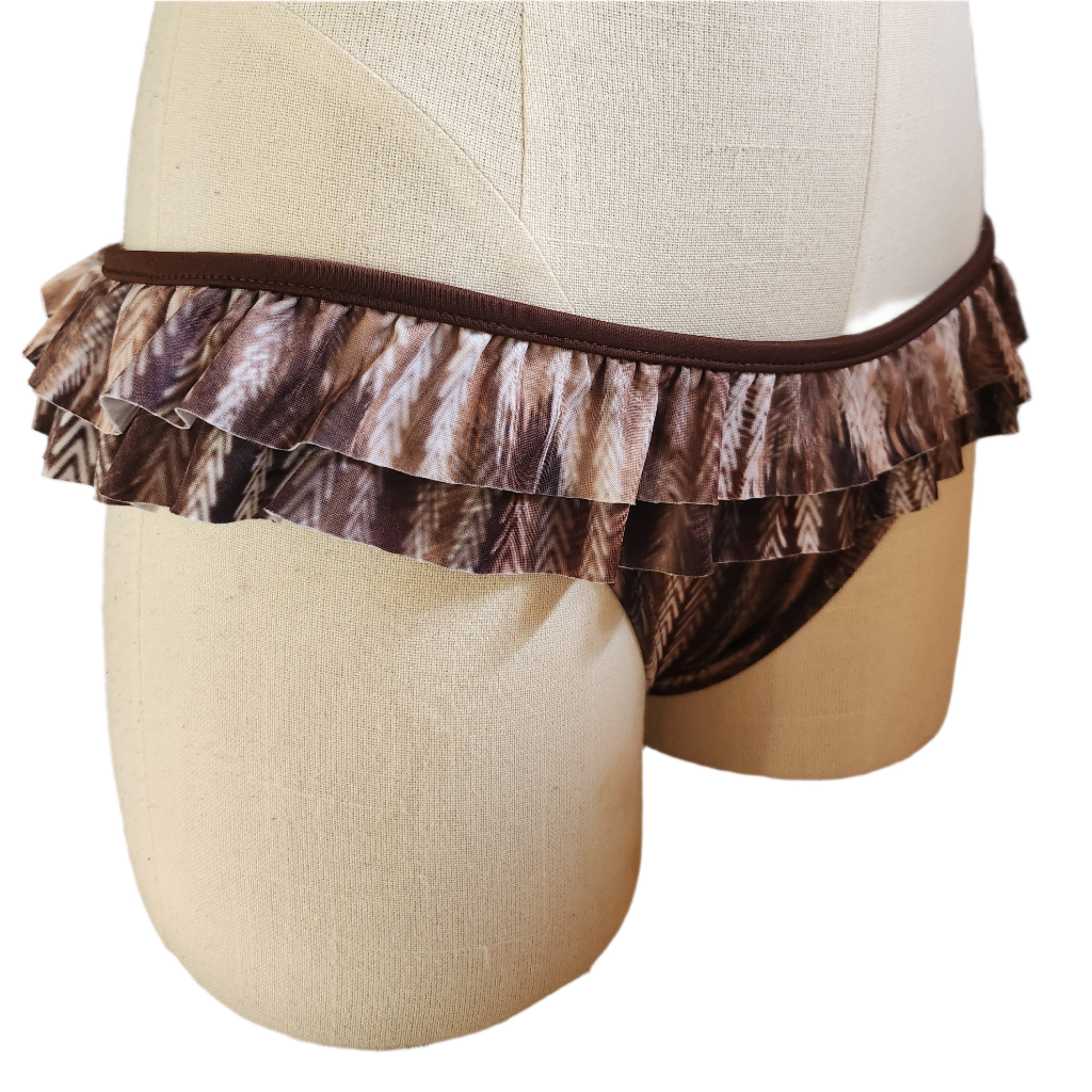 Mannequin wearing a brown ruffled bikini bottom with a white background