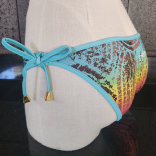 A multicolored bandana print bikini bottom with removable bows in brown, and blue tones.