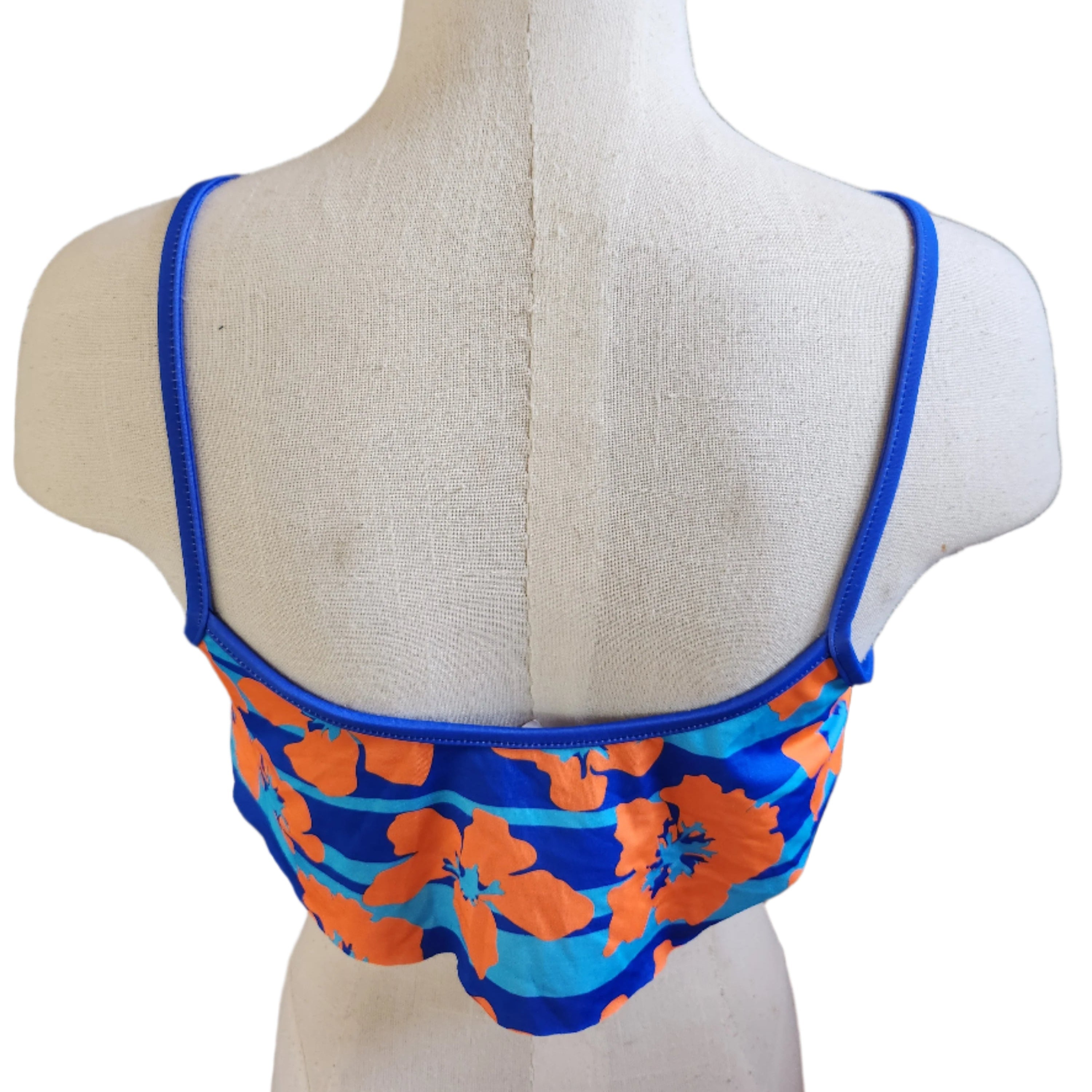 Floral bikini top on a mannequin against a white background.