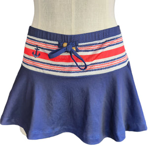 Navy skirt with a striped waistband featuring an anchor design on a mannequin.