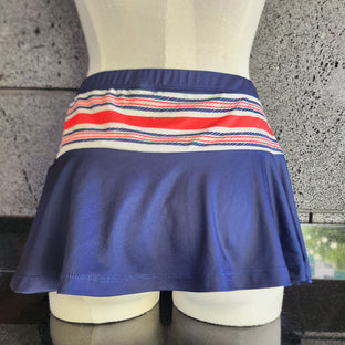 Navy skirt with a striped waistband featuring an anchor design on a mannequin.