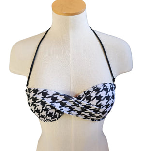Black and white houndstooth patterned bikini top on a mannequin with a white background