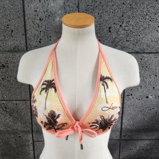 Underwire bikini top with palm tree design on a mannequin against a gray tiled floor.