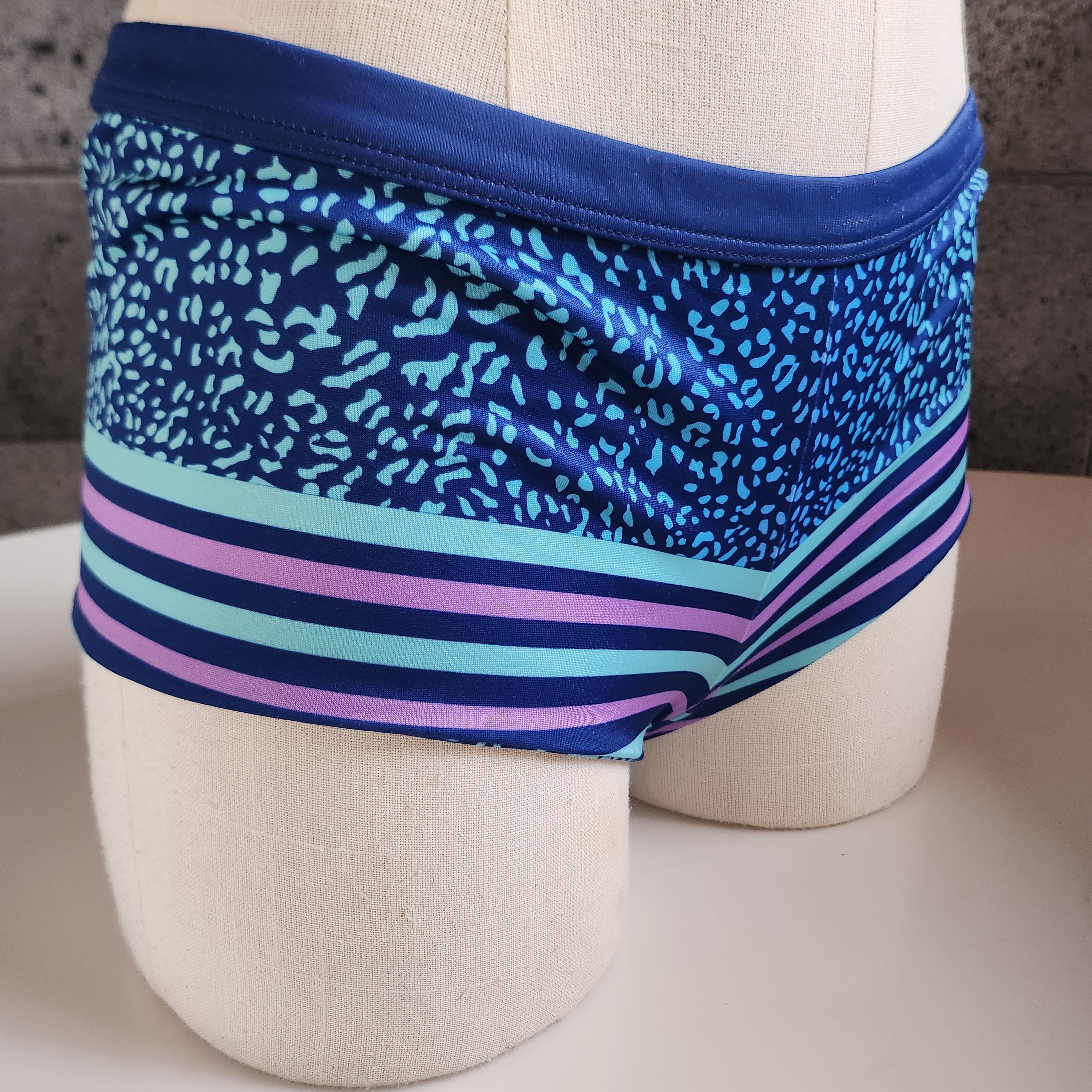 Blue patterned boyshort on a mannequin against a neutral background