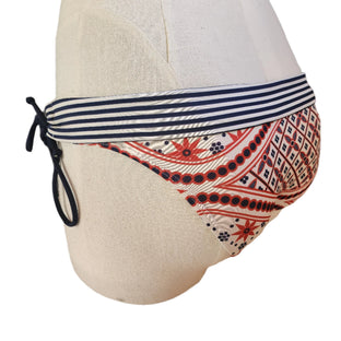 Folded over bikini bottom with stripe and batik pattern on a mannequin against a white background