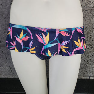 Colorful tropical leaf patterned skirted swim bottom on a model against a white background
